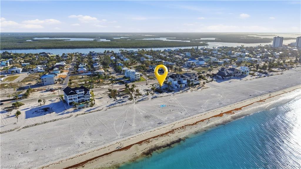 Aerial view of residential area featuring a nearby body of water - Virtually Edited Image