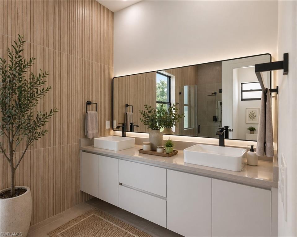 Dual vessel sinks set atop a floating vanity with integrated storage