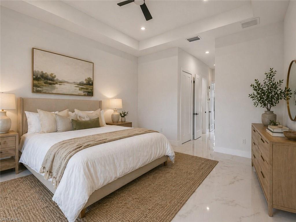 Recessed lighting and ceiling fan complement the tray ceiling