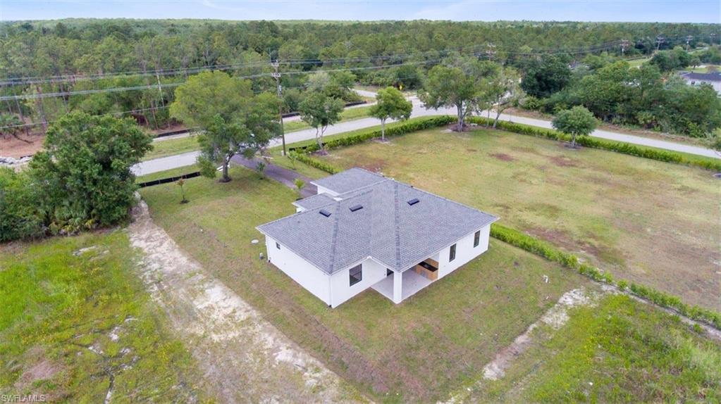 Single-story residence featuring a gray shingle roof with multiple skylights