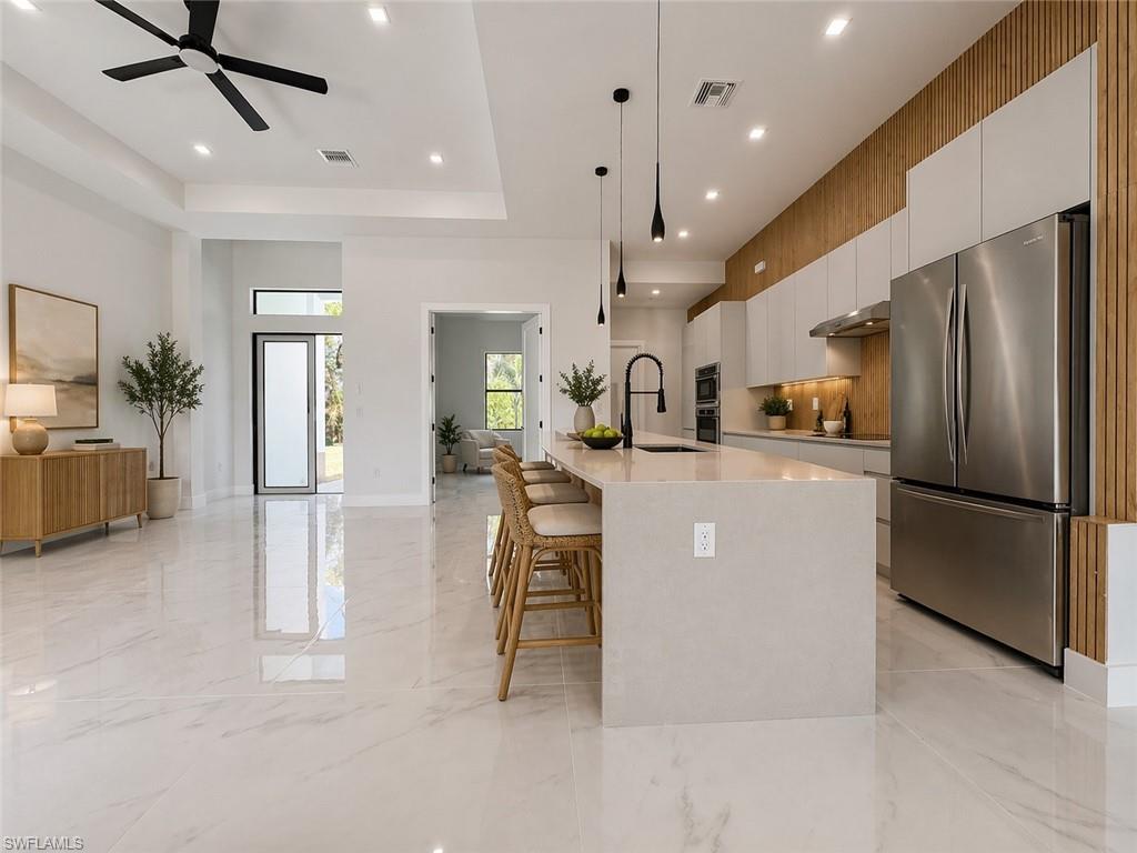 Open-concept living space with large format porcelain tile flooring