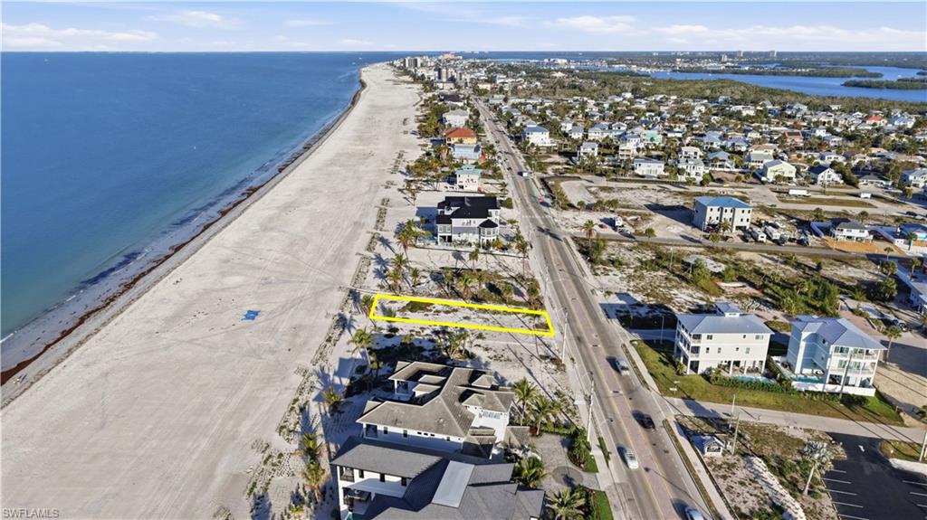 Aerial view of residential area featuring property parcel outlined and unending shoreline - Virtually Edited Image