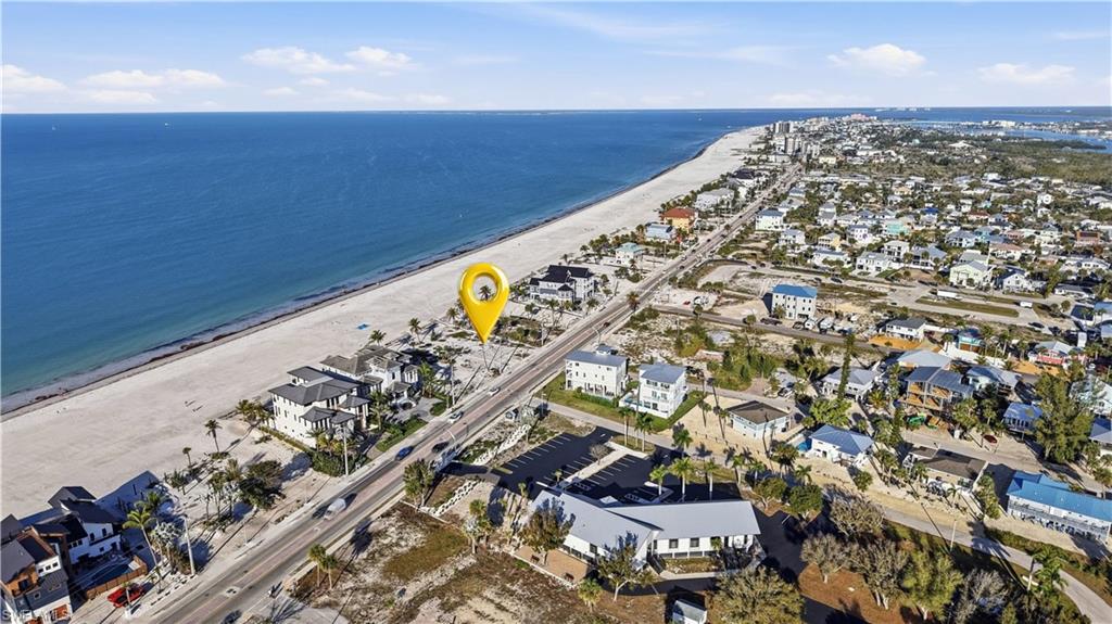 Aerial perspective of suburban area featuring waterfront with a beach - Virtually Edited Image