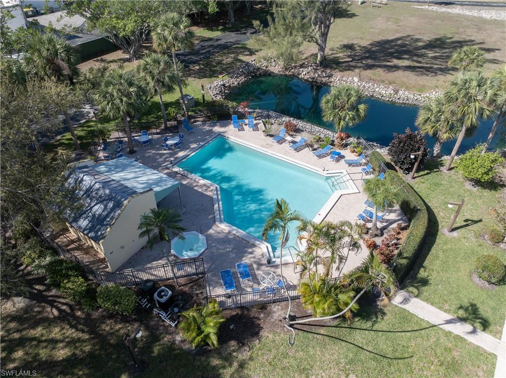 Aerial view of a pool area and a large body of water