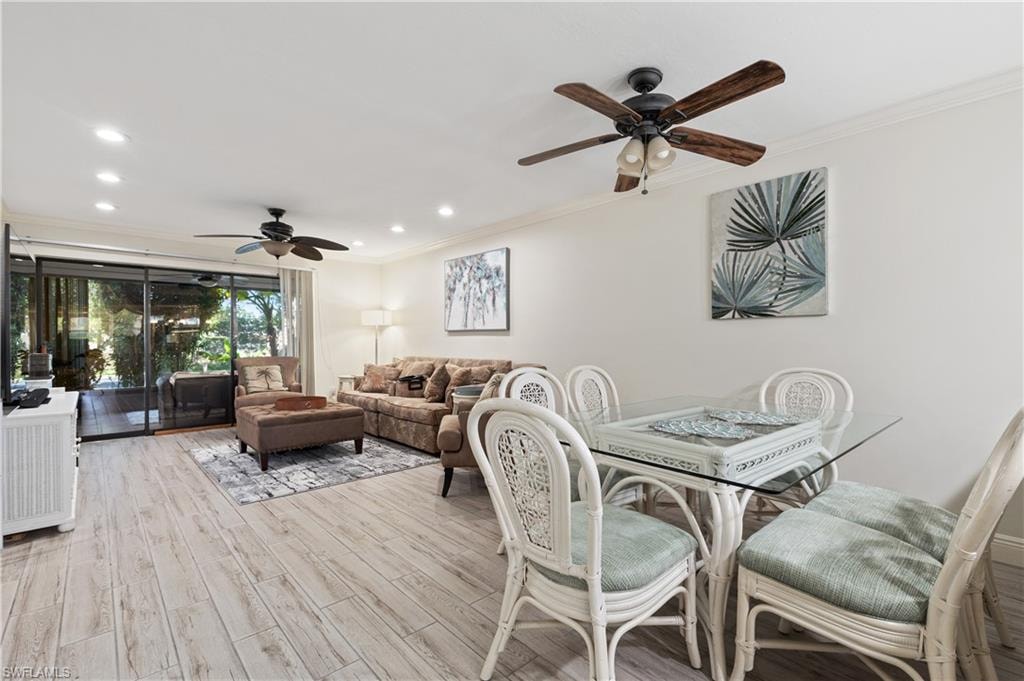 Dining area featuring ceiling fan, light wood-type flooring, crown molding, and recessed lighting