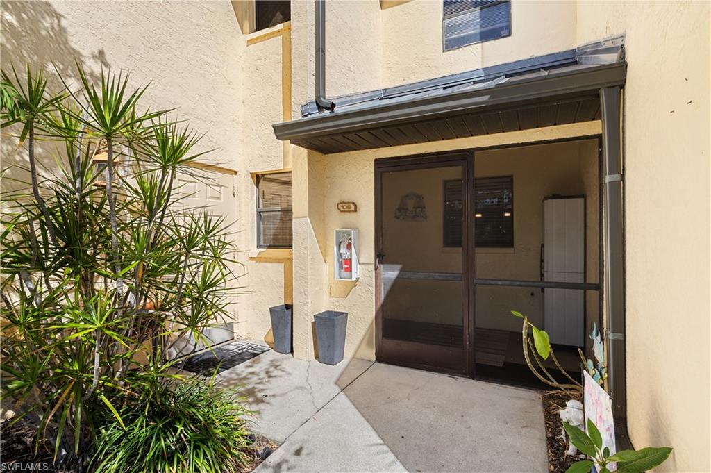 Entrance to property with stucco siding
