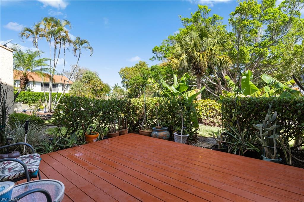 Wooden deck with a fenced backyard