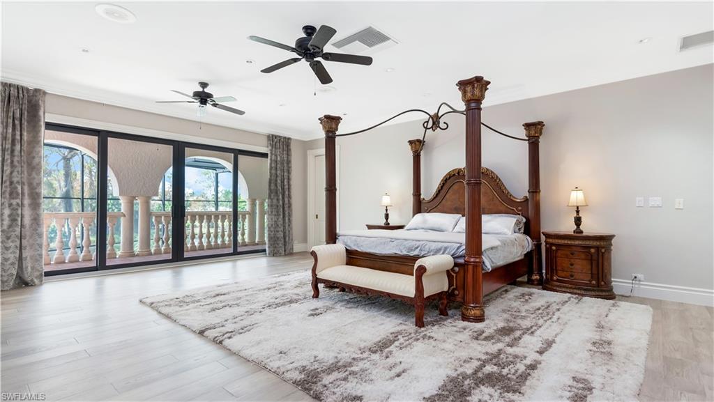 master bedroom featuring access to outside, light wood-style flooring, ceiling fan, and ornamental molding