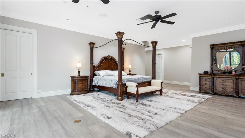 Bedroom featuring light wood-style flooring, ornamental molding, a ceiling fan, and recessed lighting