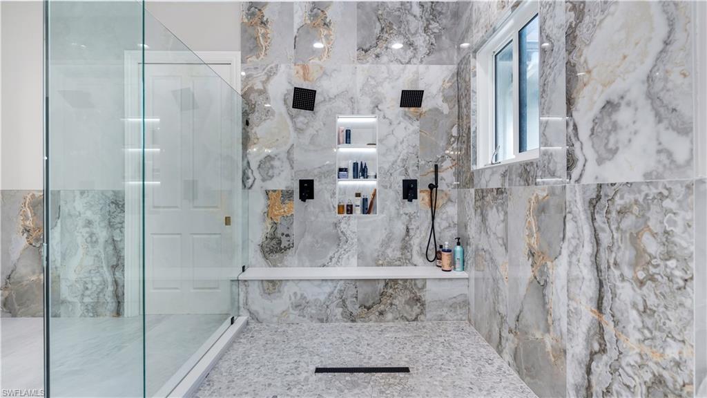 Bathroom featuring a marble finish shower