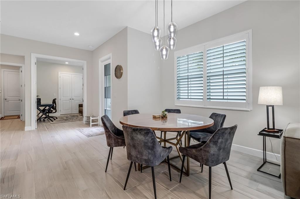 Dining space featuring recessed lighting, light wood-style floors, and baseboards