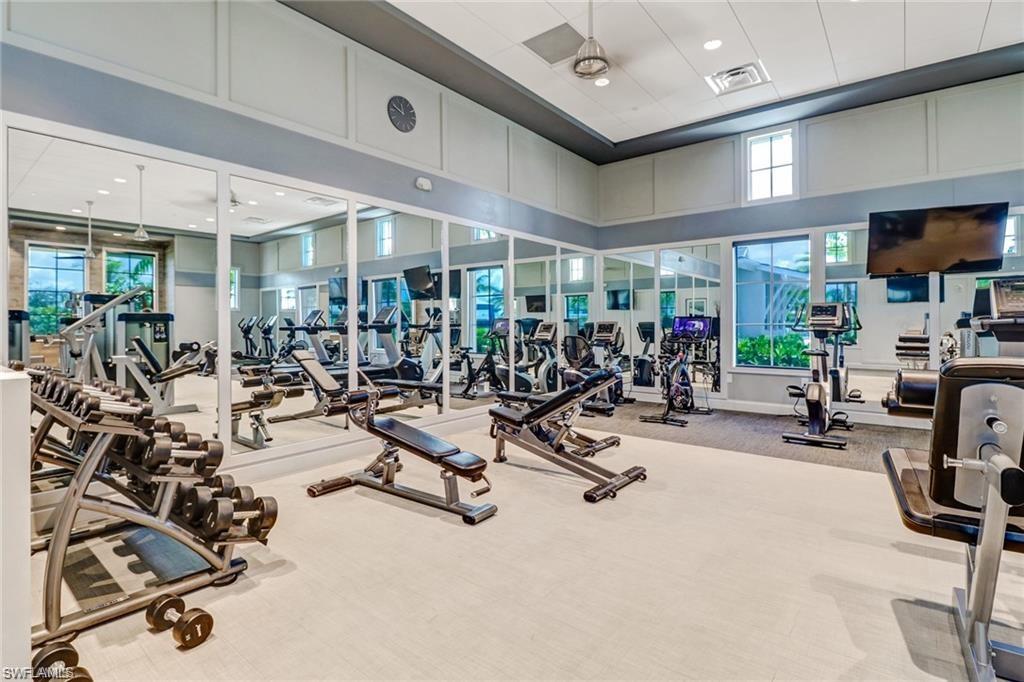 Gym with visible vents, a high ceiling, and carpet floors