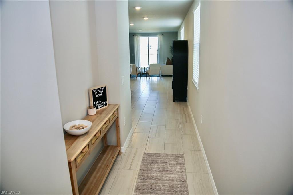 Corridor with baseboards and recessed lighting