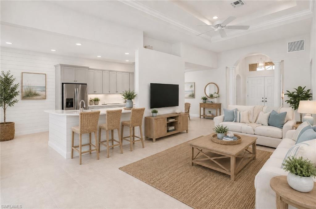 Photo shows home reimagined with white paint on walls, painted kitchen cabinets and updated furnishing. AI GENERATED