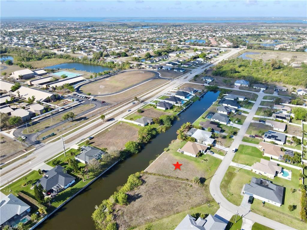 Aerial overview of property's location with a large body of water and nearby suburban area