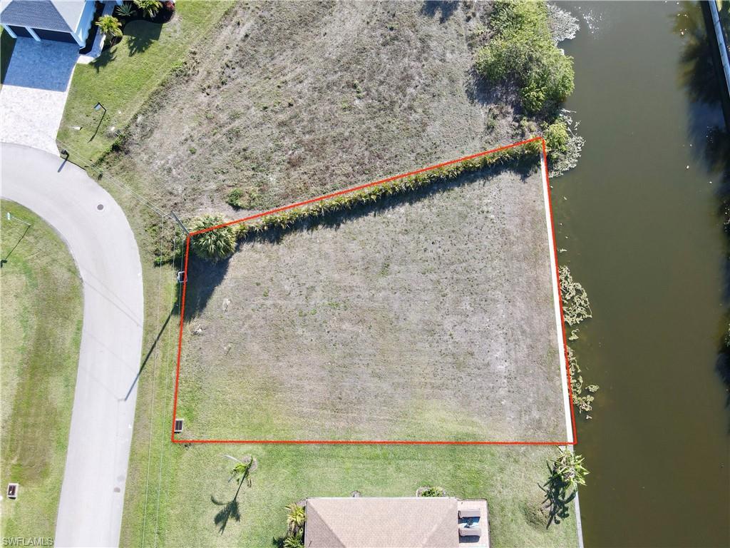 Aerial view of property's location featuring a large body of water and property parcel outlined