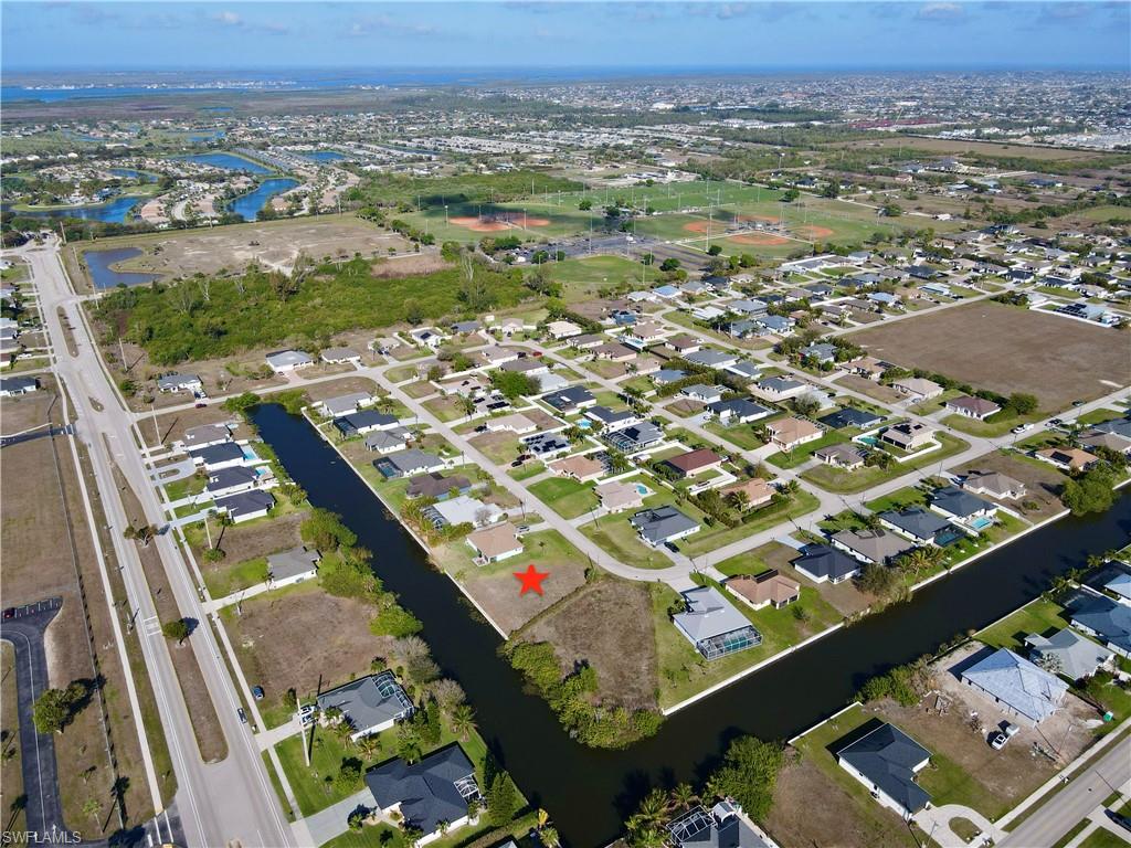 View of property location with a nearby body of water and nearby suburban area