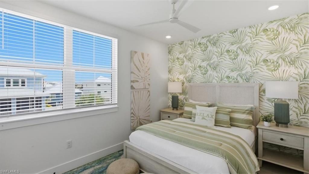 Bedroom featuring wallpapered walls, recessed lighting, ceiling fan, and an accent wall - Virtually Edited