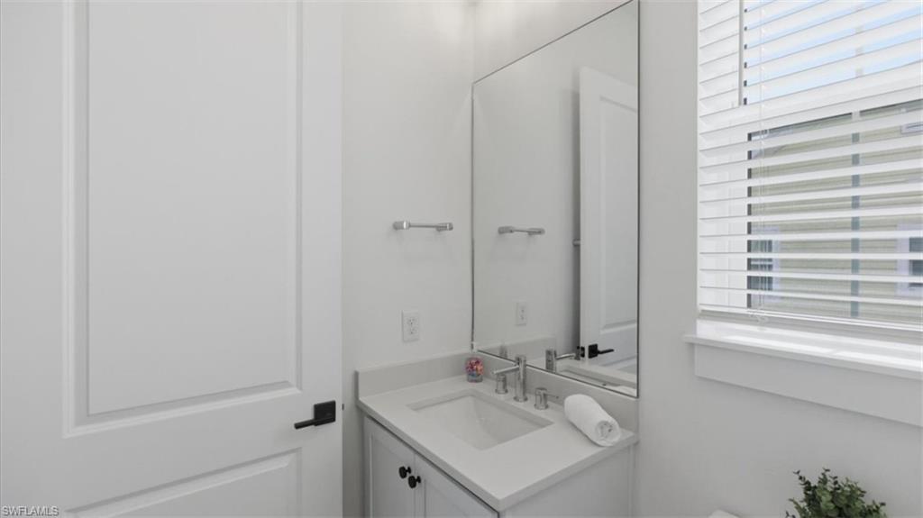 Half bath with vanity and toilet - Virtually Edited