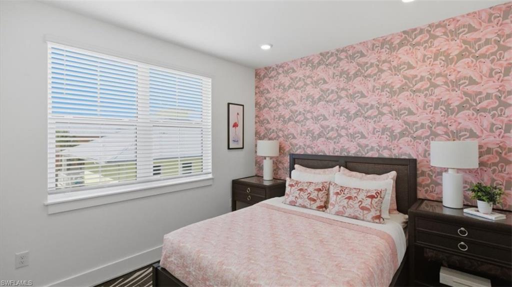 Bedroom featuring wallpapered walls, recessed lighting, and an accent wall - Virtually Edited