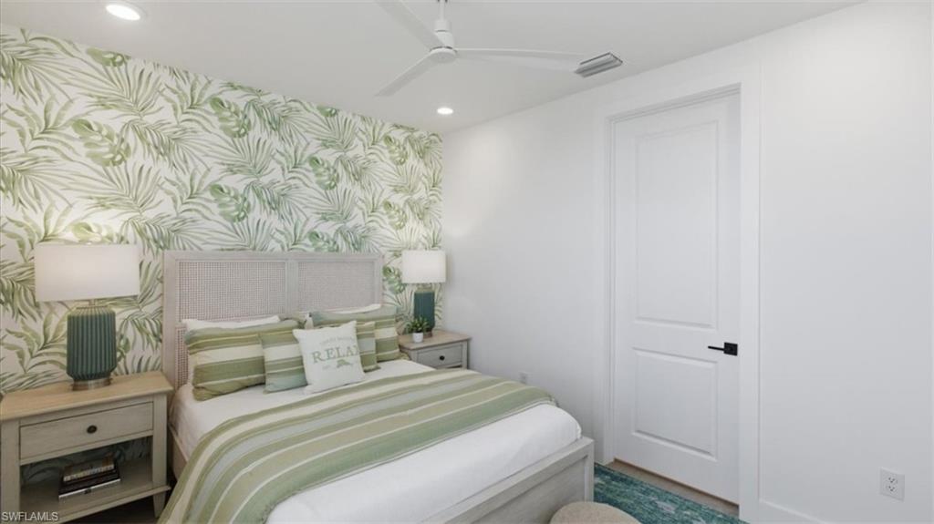 Bedroom featuring wallpapered walls, an accent wall, recessed lighting, and ceiling fan - Virtually Edited