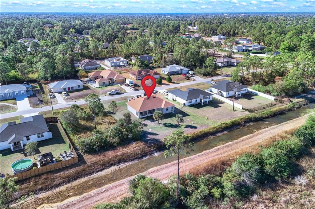 Aerial view of residential area featuring a nearby body of water