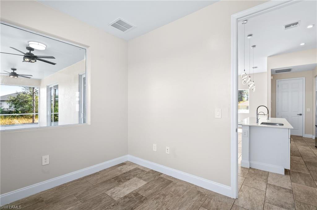 Spare room featuring ceiling fan and light wood-type flooring