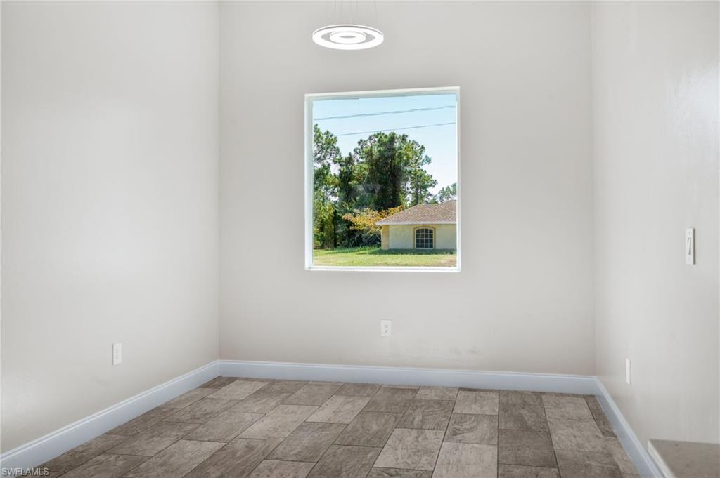 Unfurnished room with baseboards