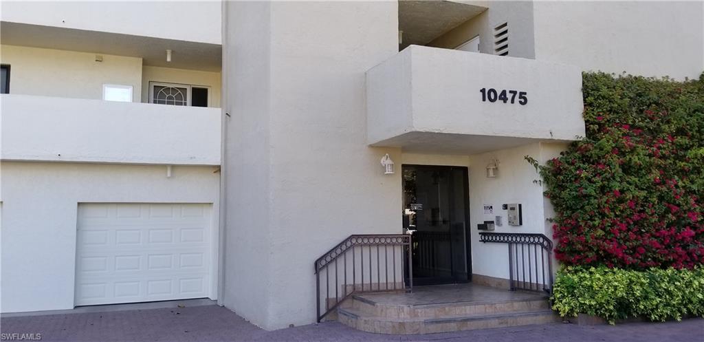 Front entrance to the lobby and elevator. Your covered garage is the first door to the left shown here.