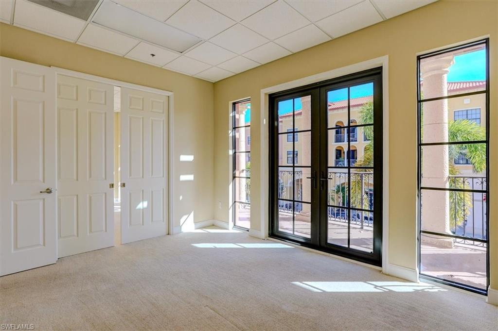 Doorway to outside with a paneled ceiling and carpet floors
