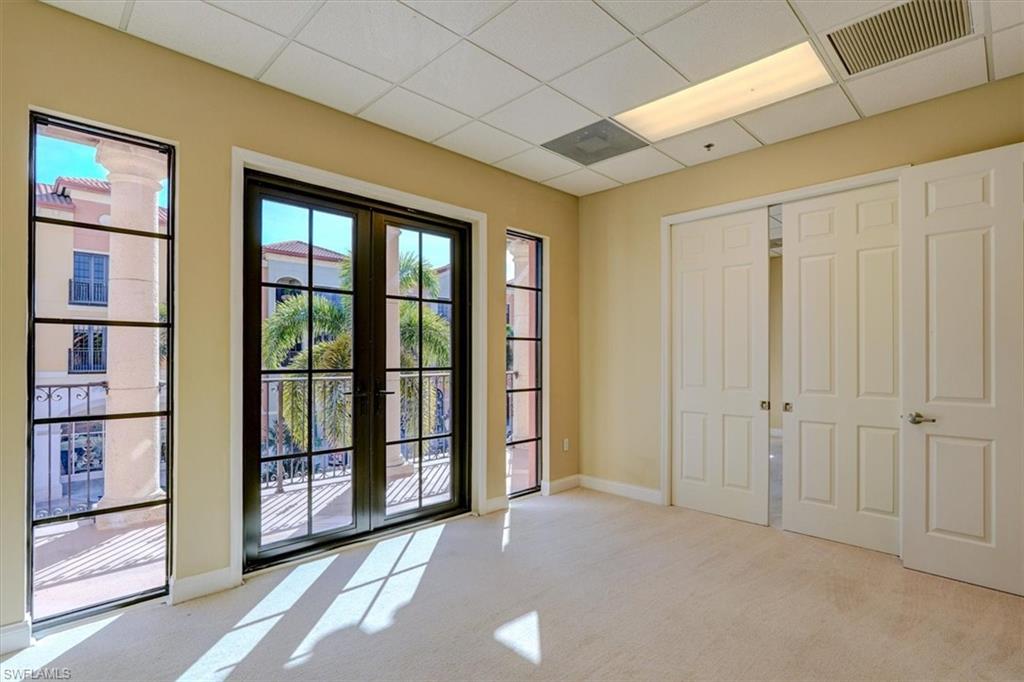 Entryway featuring french doors, a paneled ceiling, and carpet