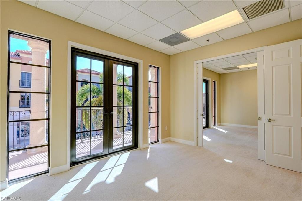 Doorway to outside with a drop ceiling, french doors, and carpet flooring