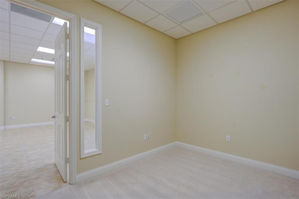 Unfurnished office featuring a transom window for extra light  ceiling