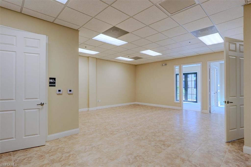 Extra large tiled open area leading to offices & balconies.  Rest room on the front left side