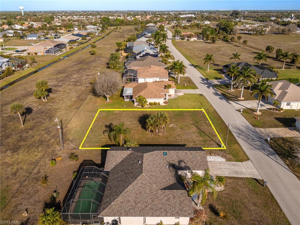 Aerial view of residential area with property parcel outlined