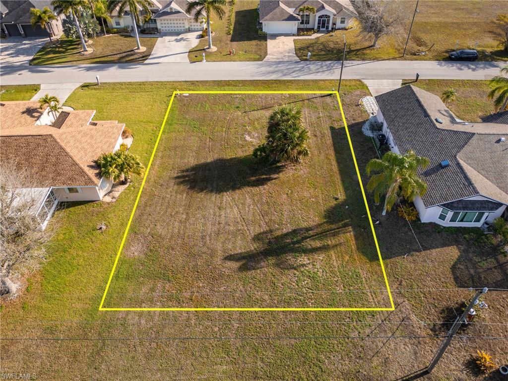 Aerial perspective of suburban area featuring property parcel outlined