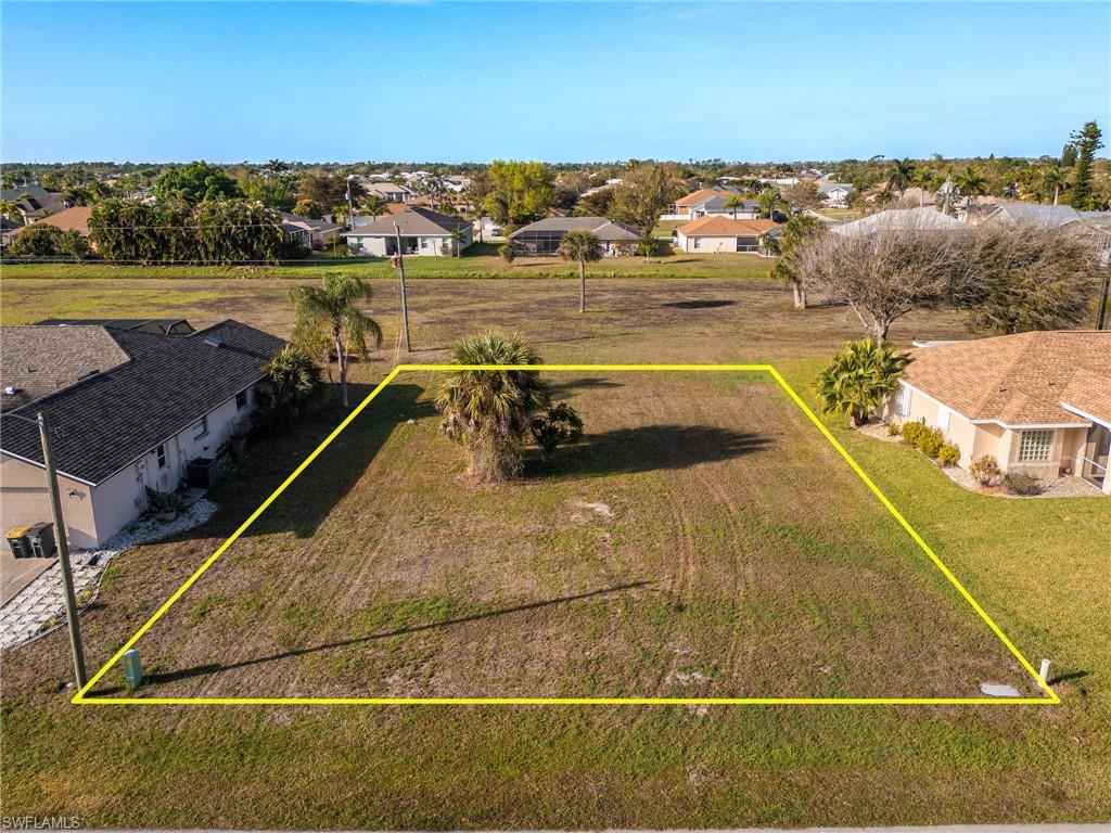 Aerial perspective of suburban area featuring property parcel outlined