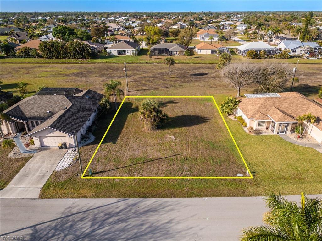 Aerial view of residential area featuring property boundaries highlighted