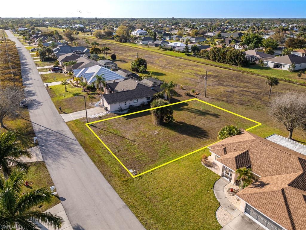 Aerial perspective of suburban area featuring property boundaries highlighted