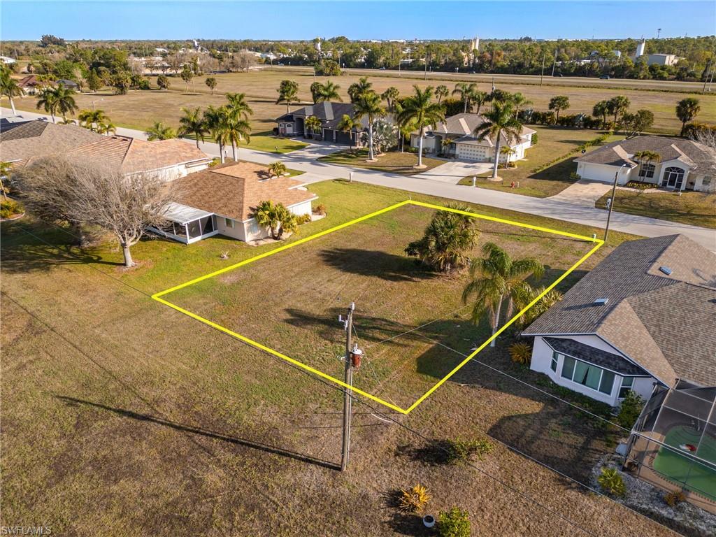 Aerial perspective of suburban area featuring property parcel outlined