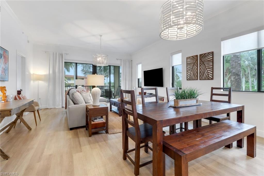 Dining space featuring light hardwood / wood-style flooring and a notable chandelier