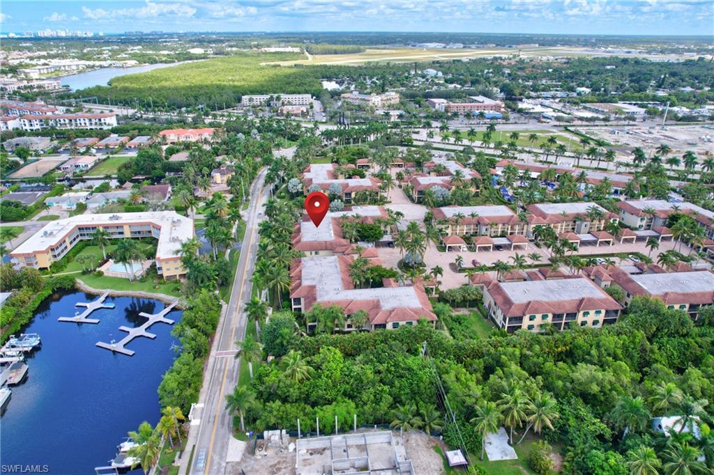 Birds eye view of property with a water view