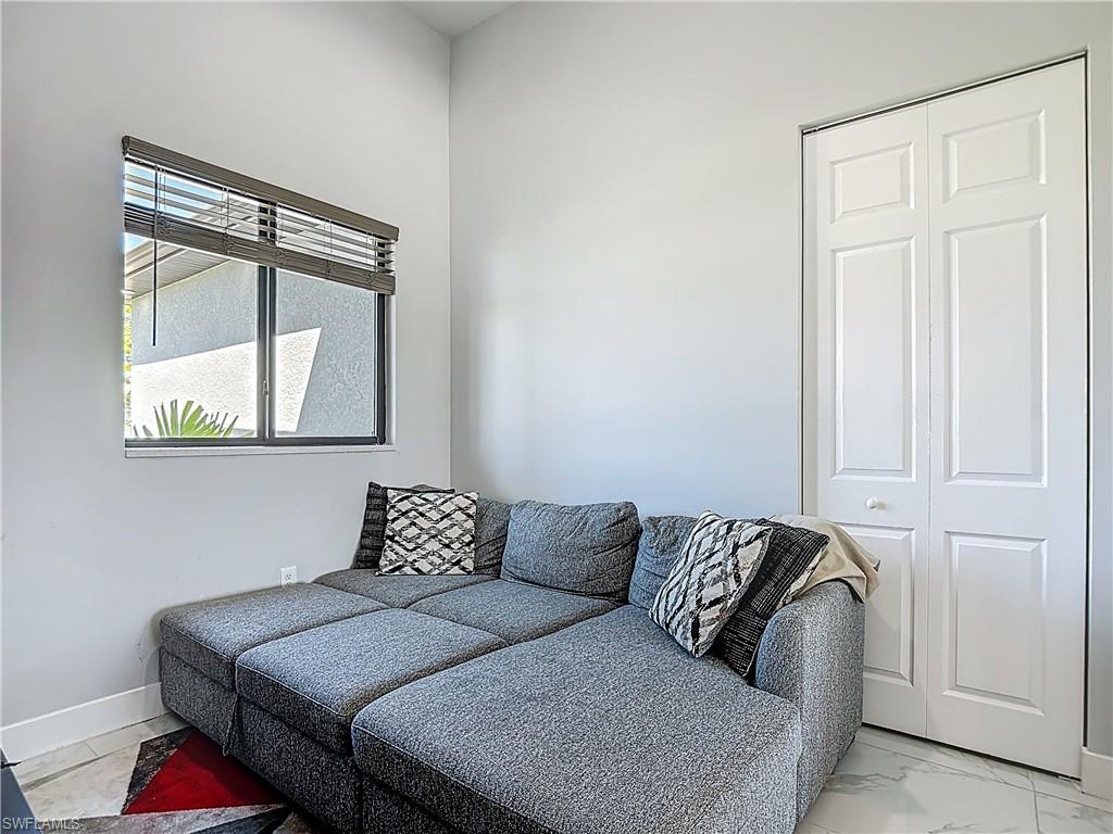 Living room with light marble finish flooring and baseboards