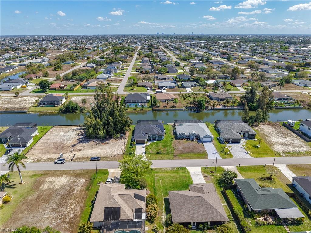 Aerial overview of property's location with nearby suburban area and a nearby body of water