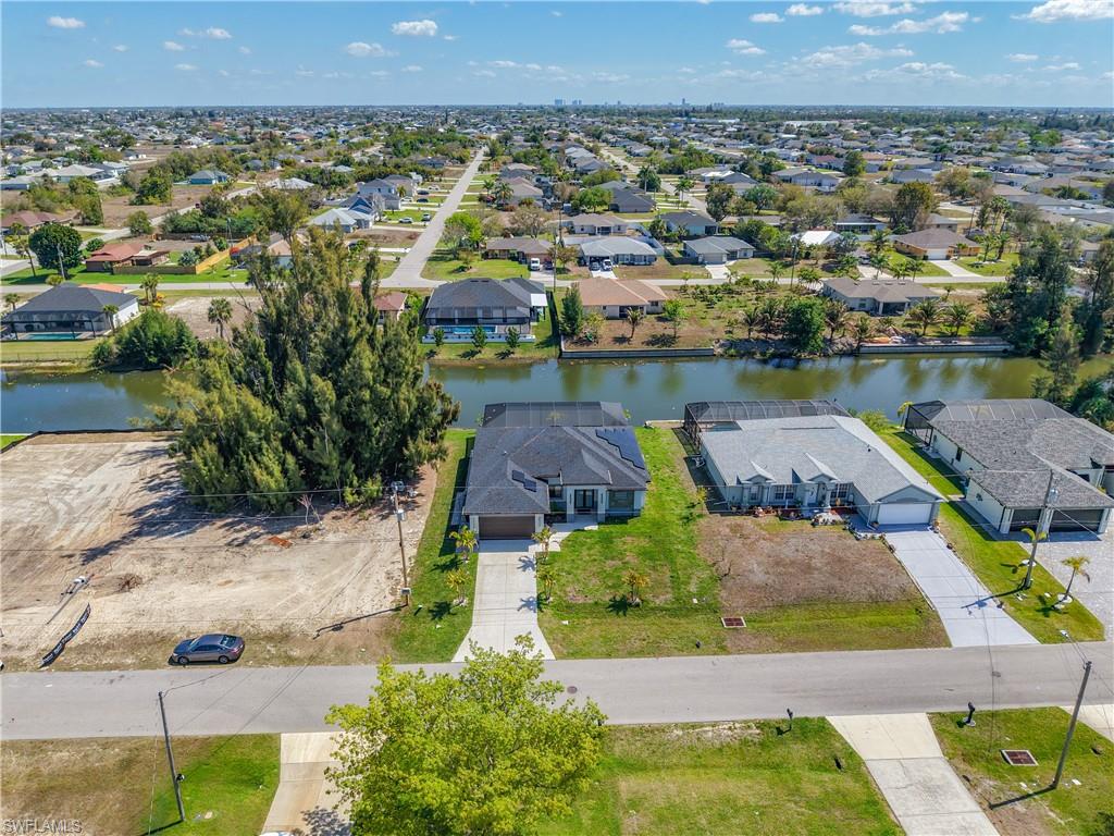 Aerial perspective of suburban area featuring a nearby body of water