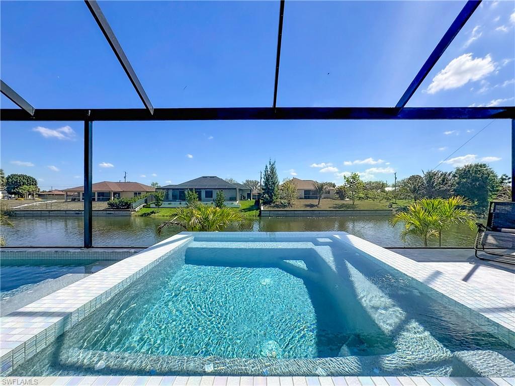 Outdoor pool featuring a lanai, a water view, and a residential view