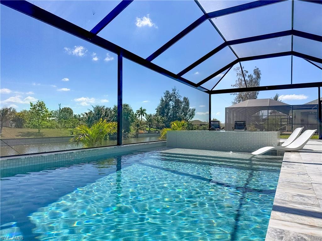Outdoor pool with a lanai and a sunroom