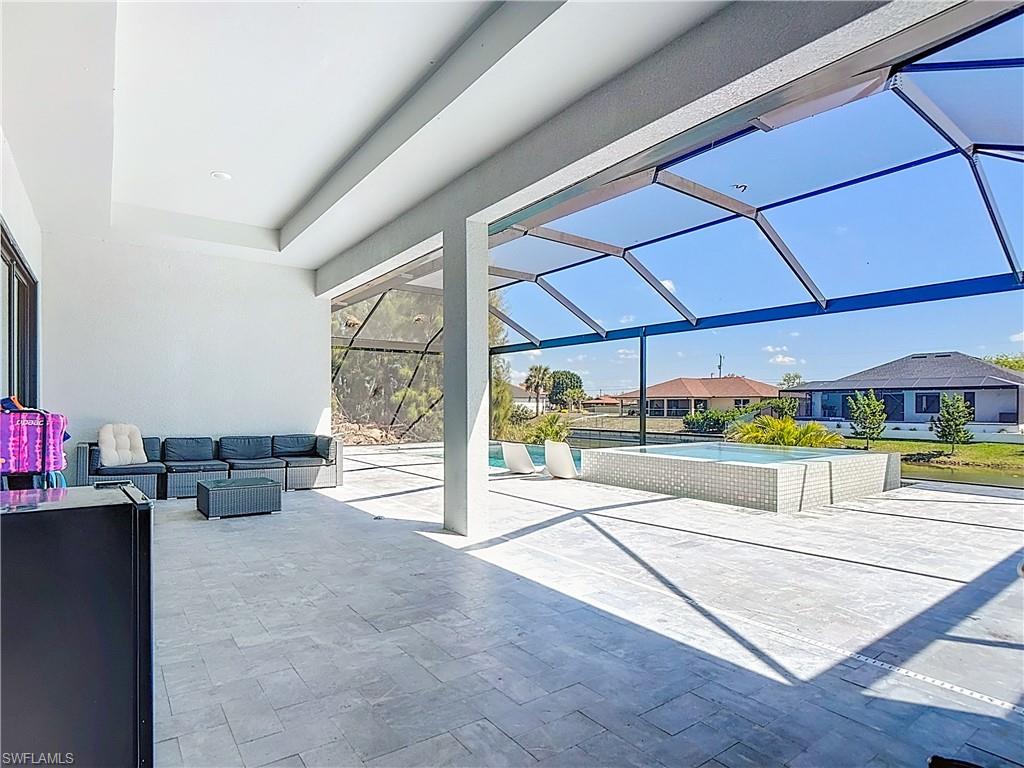View of patio featuring a sunroom, an outdoor pool, a lanai, a residential view, and outdoor seating