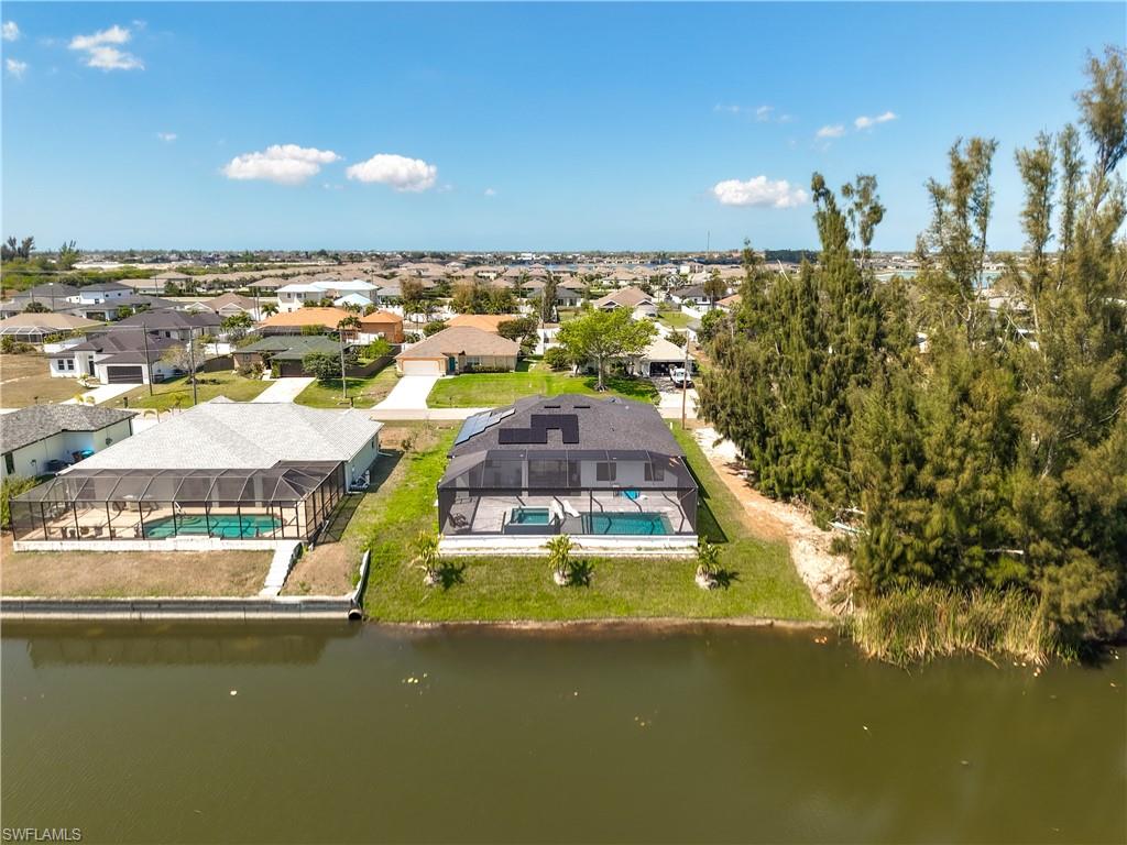 Aerial perspective of suburban area with a nearby body of water