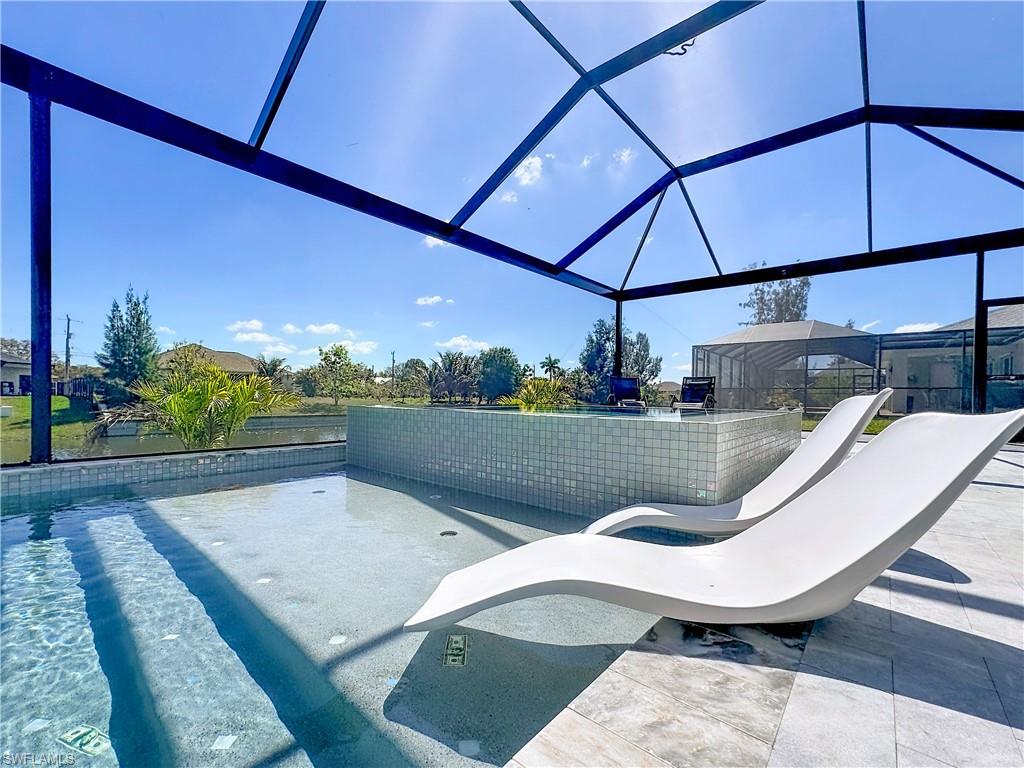 Outdoor pool with a lanai, a sunroom, and a patio